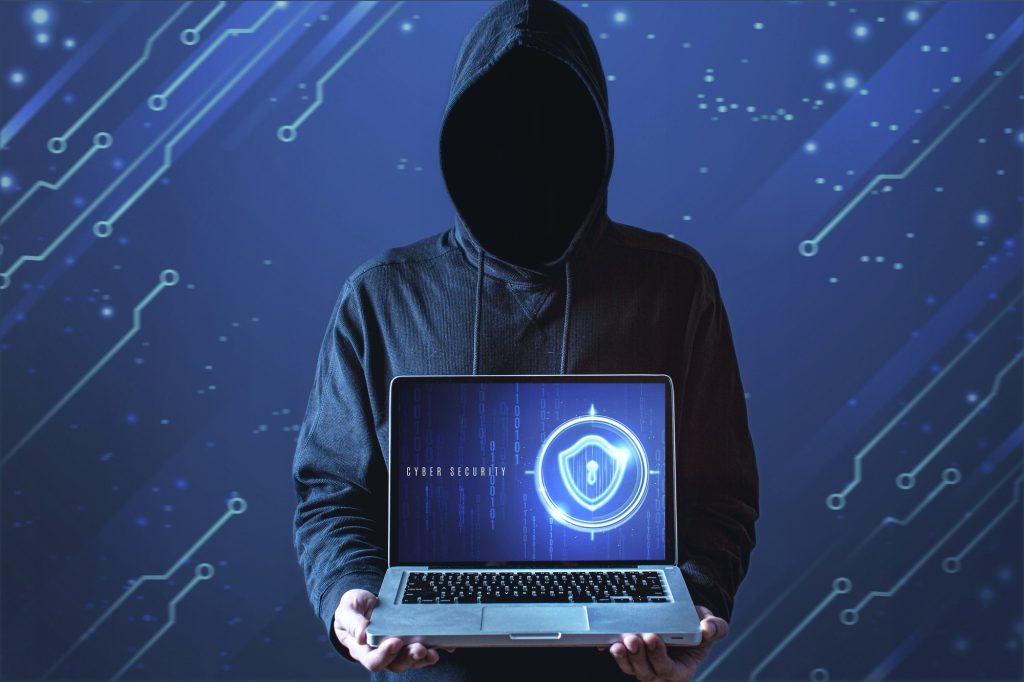 medium shot man with hoodie holding laptop